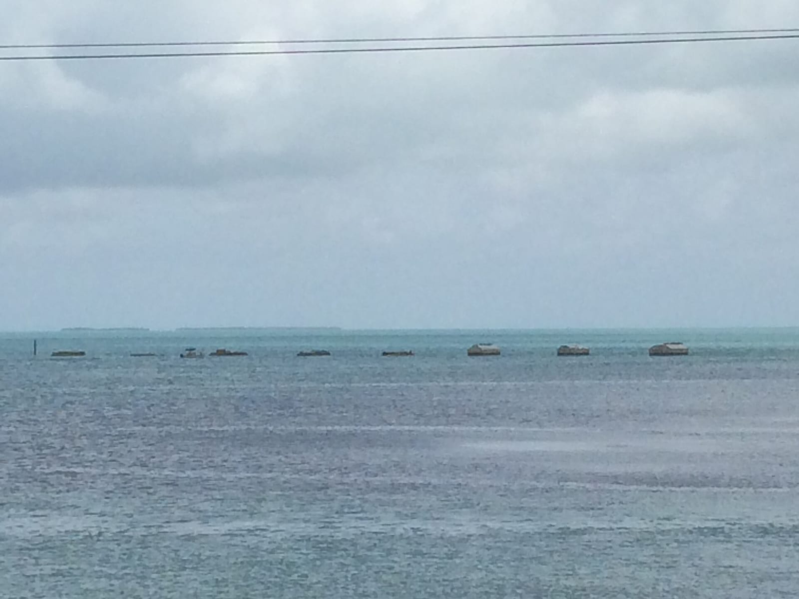 Anne's Beach: moored boats in shallow water with cloudy sky