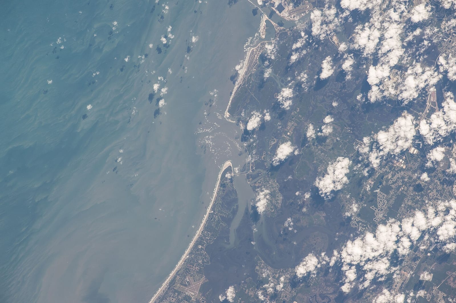 Apollo Beach: aerial view of coastline with beach, water, and cloud cover