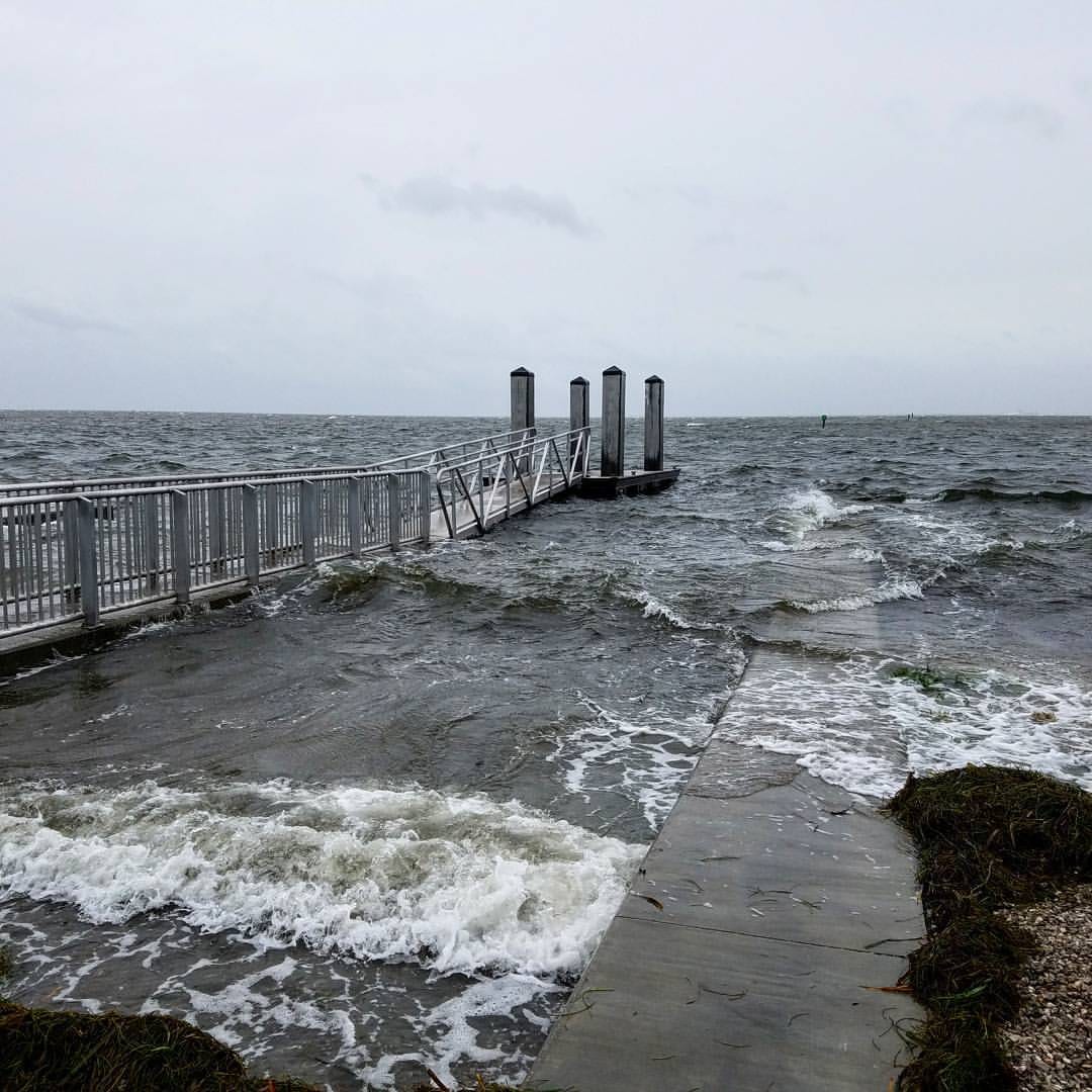 Bahama Beach: pier with walkway extends into ocean with breaking waves