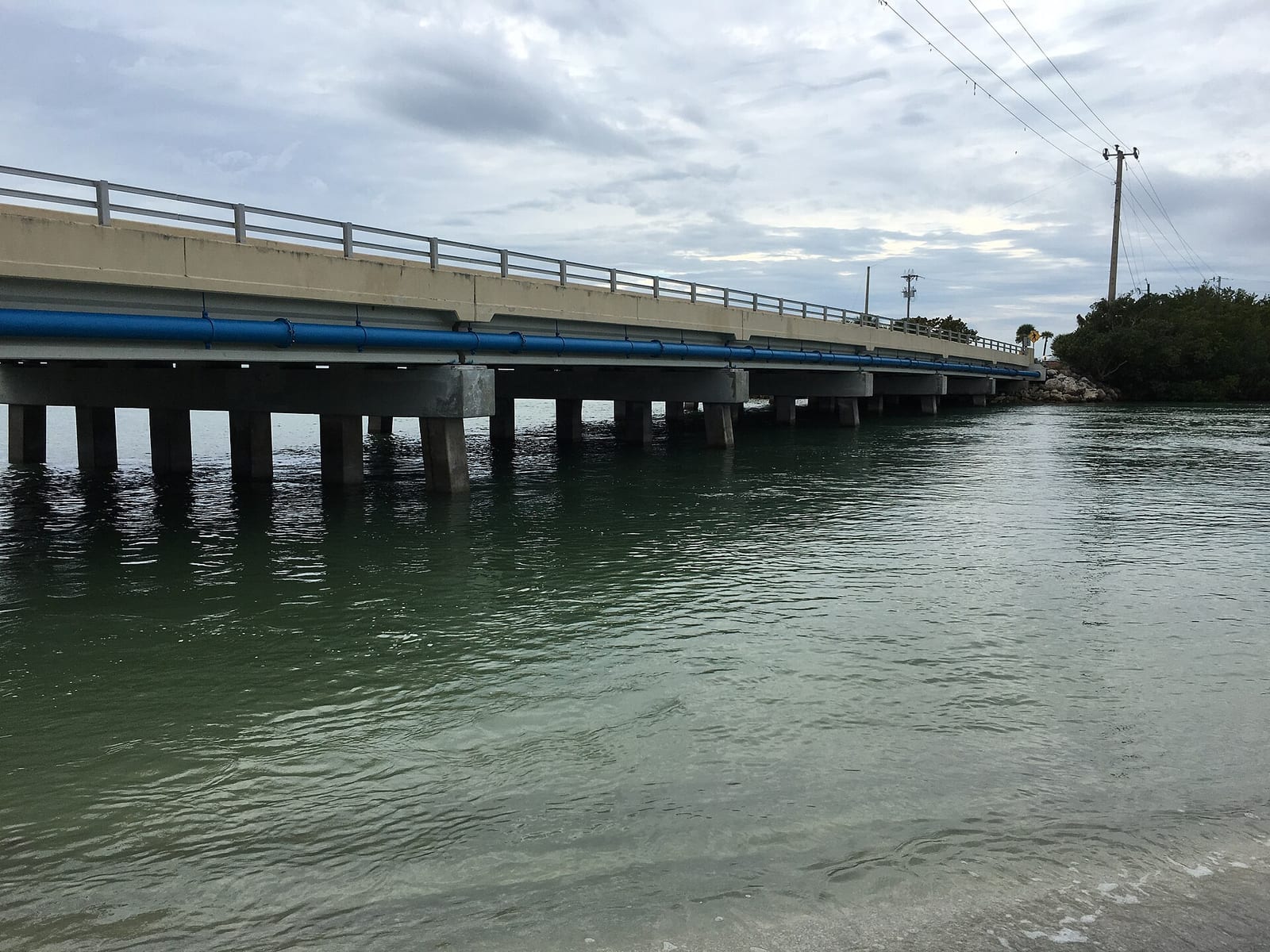 Blind Pass Beach: bridge over shallow water with beach visible in foreground