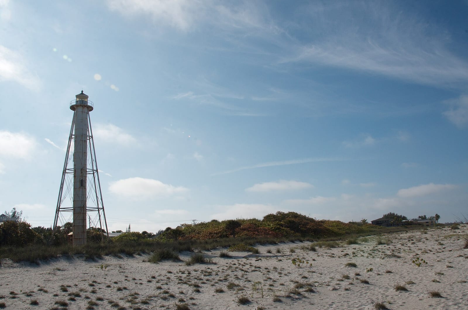 Boca Beach: lighthouse on sandy beach with dunes and vegetation visible