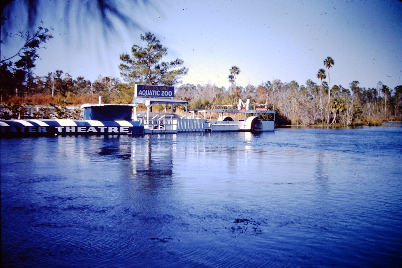 Buccaneer Bay: aquatic zoo and theatre structures along waterway with trees