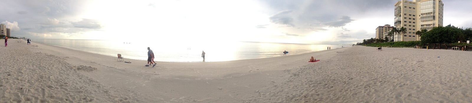 Channel Drive Beach: wide sandy beach with scattered people, buildings and sky
