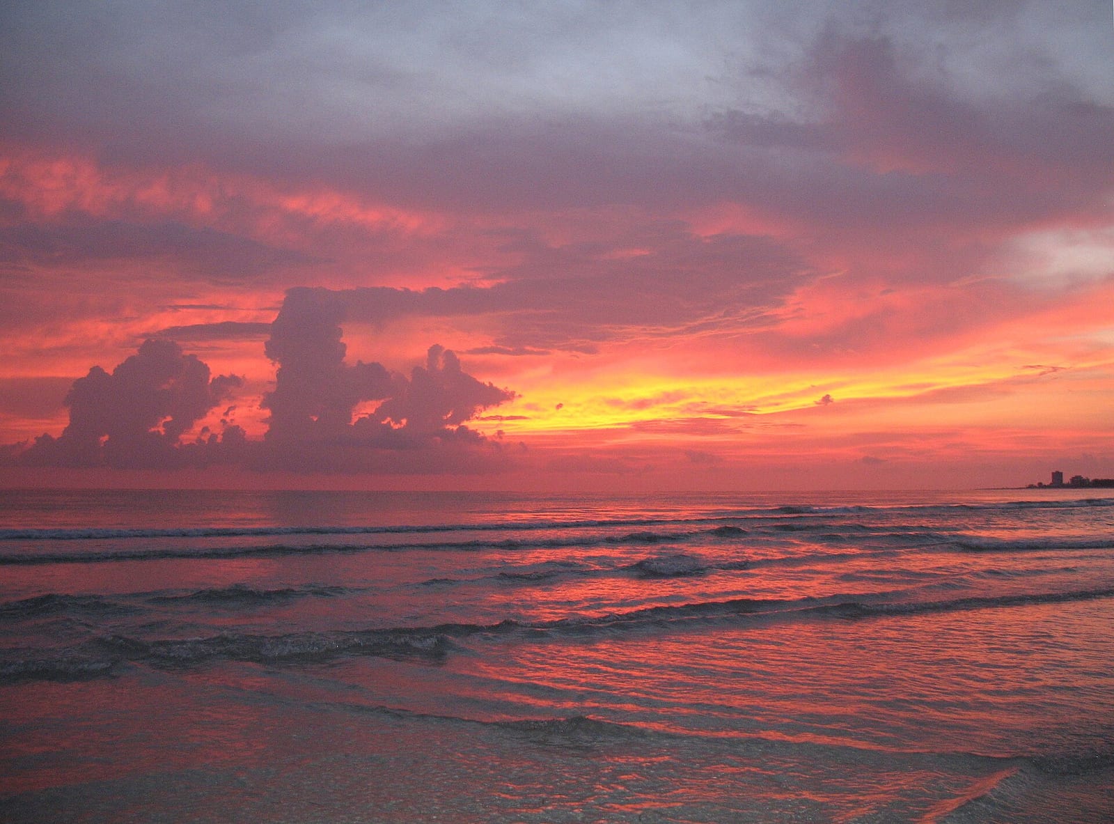 Crescent Beach: sunset over ocean with dramatic clouds and waves on shore
