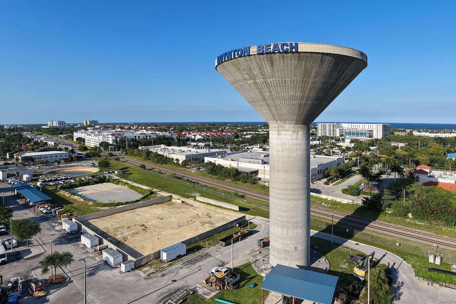 Delray Public Beach: water tower labeled Milton Beach overlooking coastal town and ocean