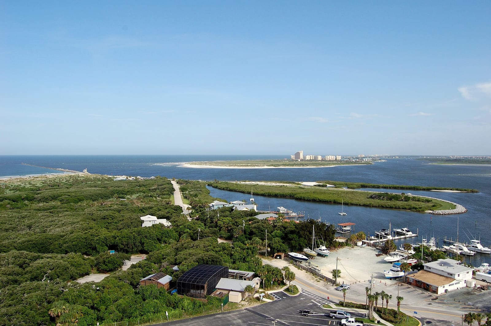 Disappearing Island: aerial view of marina, mangrove forests, waterways, and distant coastal development