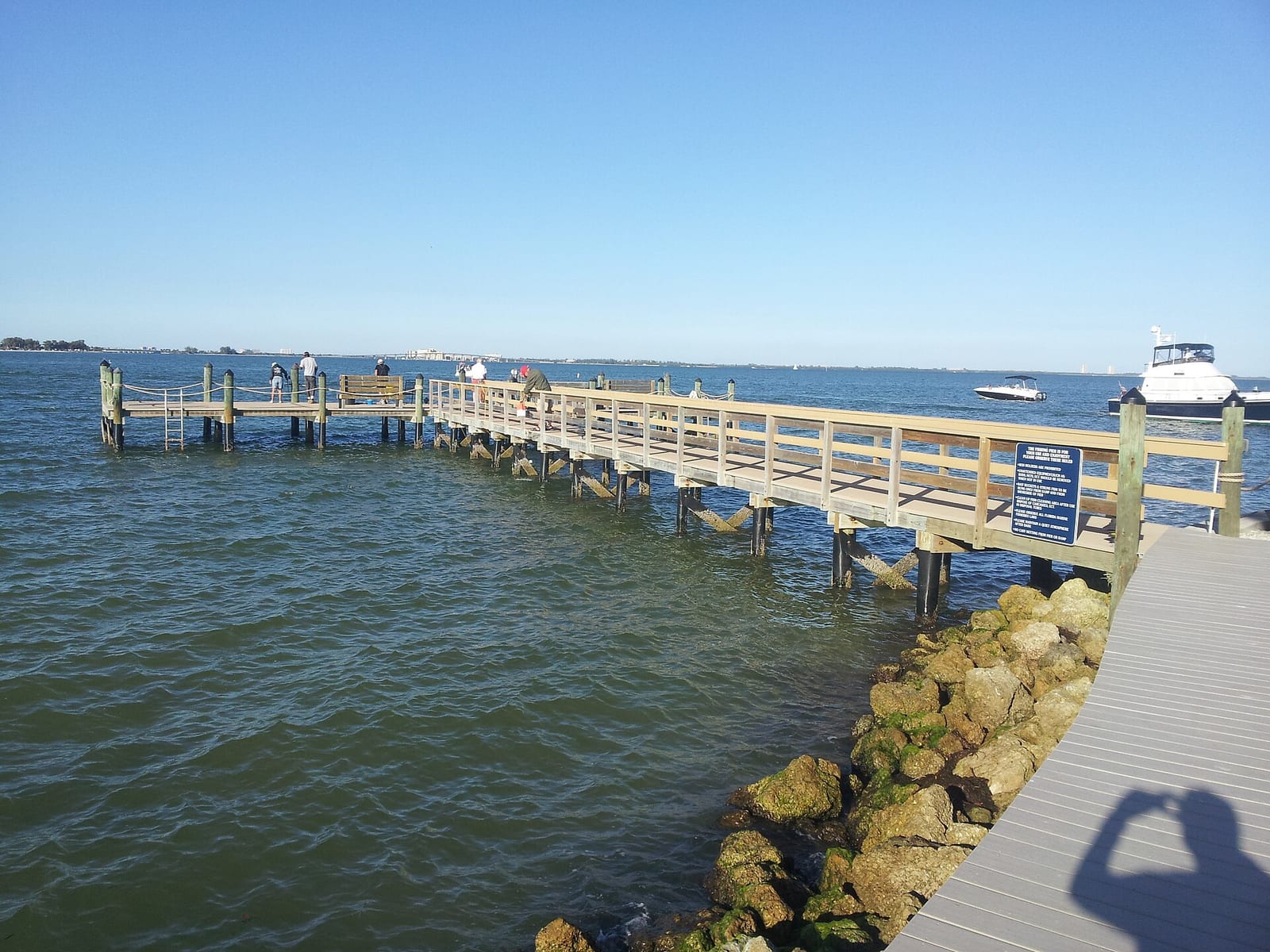 Dixie Beach: wooden pier and docks extending into calm blue water with boats
