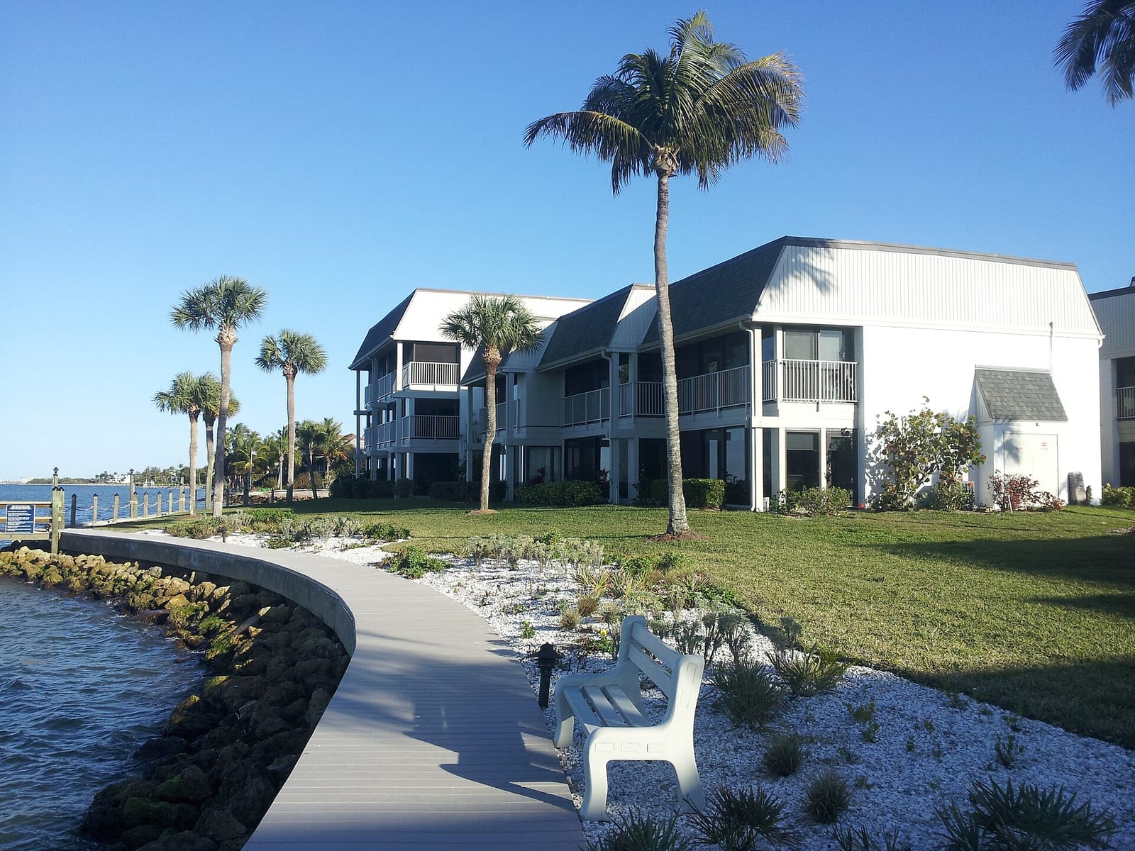 Dixie Beach: waterfront residential buildings with palm trees and sandy beach access