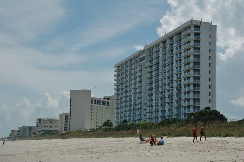 Eau Gallie Beach: beach with high-rise hotels, sand, ocean, and distant beachgoers