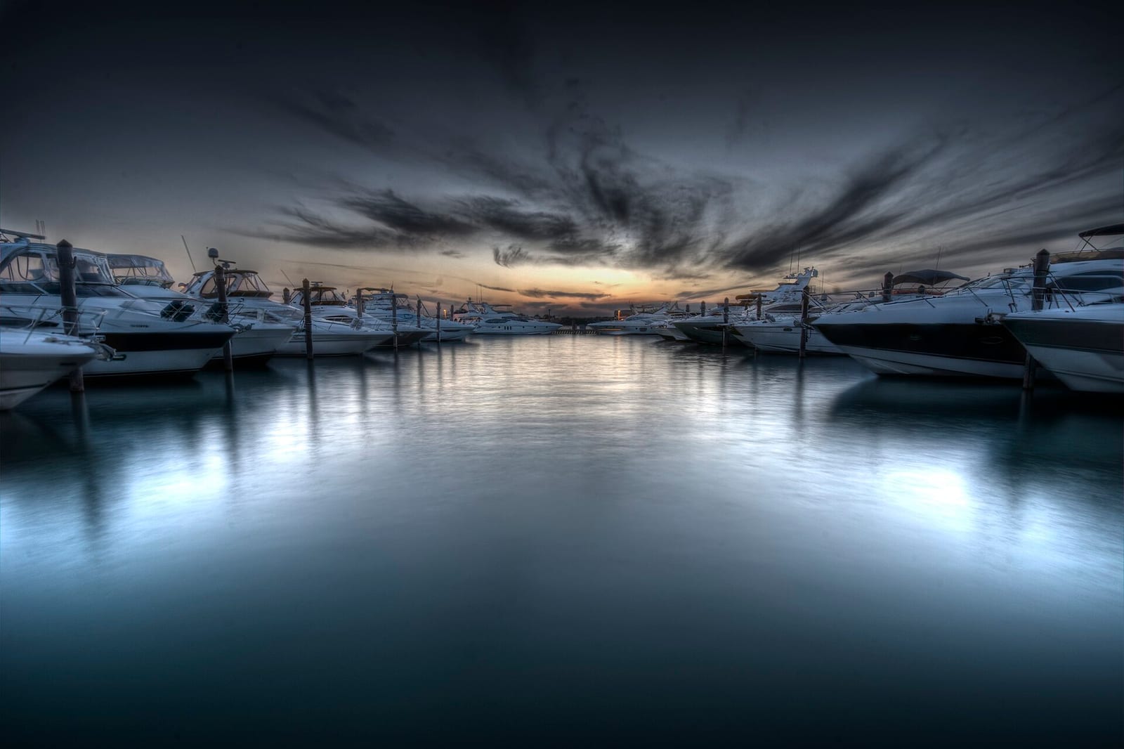 Haulover Beach: marina with moored boats at sunset, dramatic sky overhead