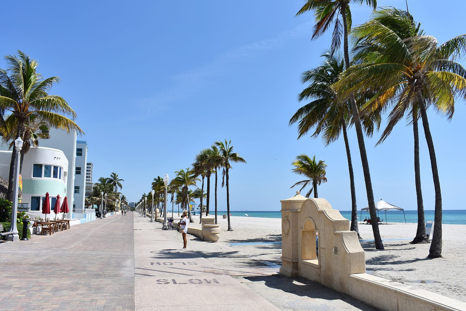 Hollywood Beach: palm-lined boardwalk with beach, ocean, and modern buildings