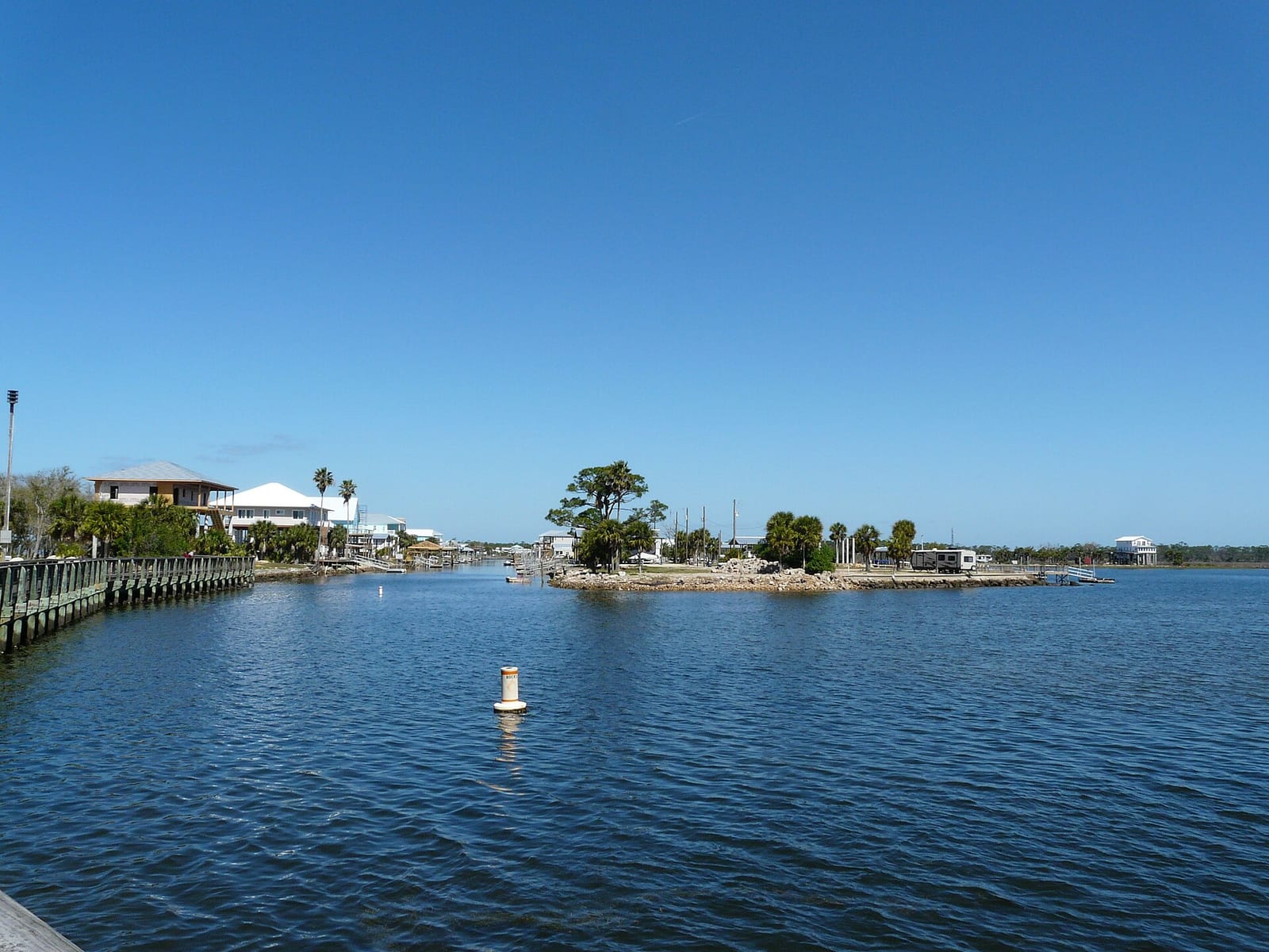 Keaton Beach: waterfront harbor view with buildings, trees, and moored boats