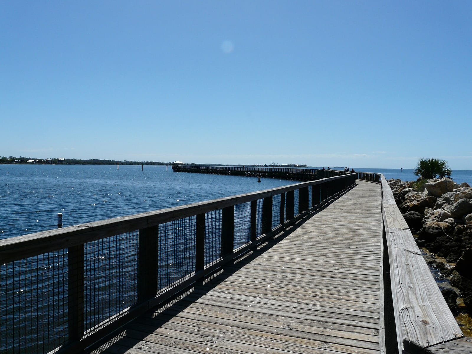 Keaton Beach: wooden boardwalk and pier extending into calm blue water