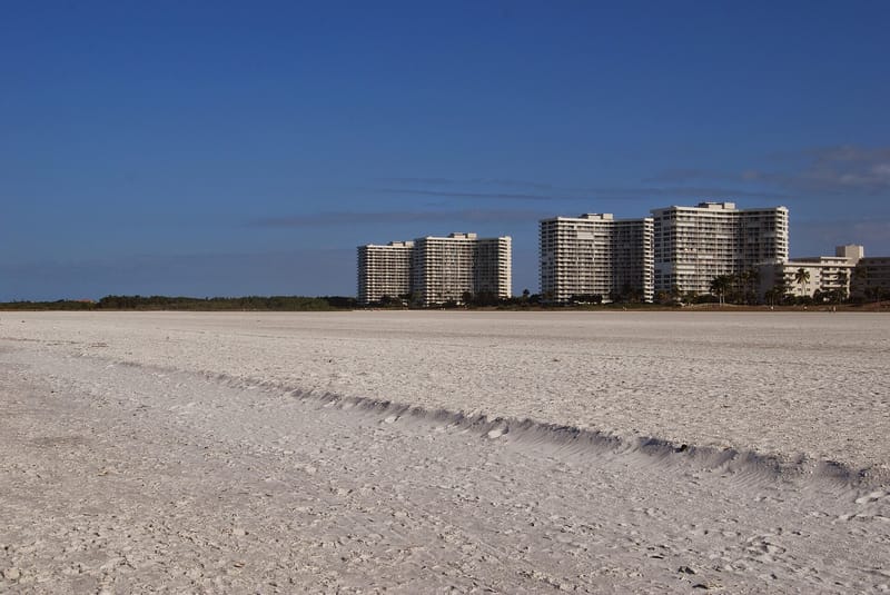 Marco Island Resident's Beach: sandy beach with wave patterns and beachfront residential buildings