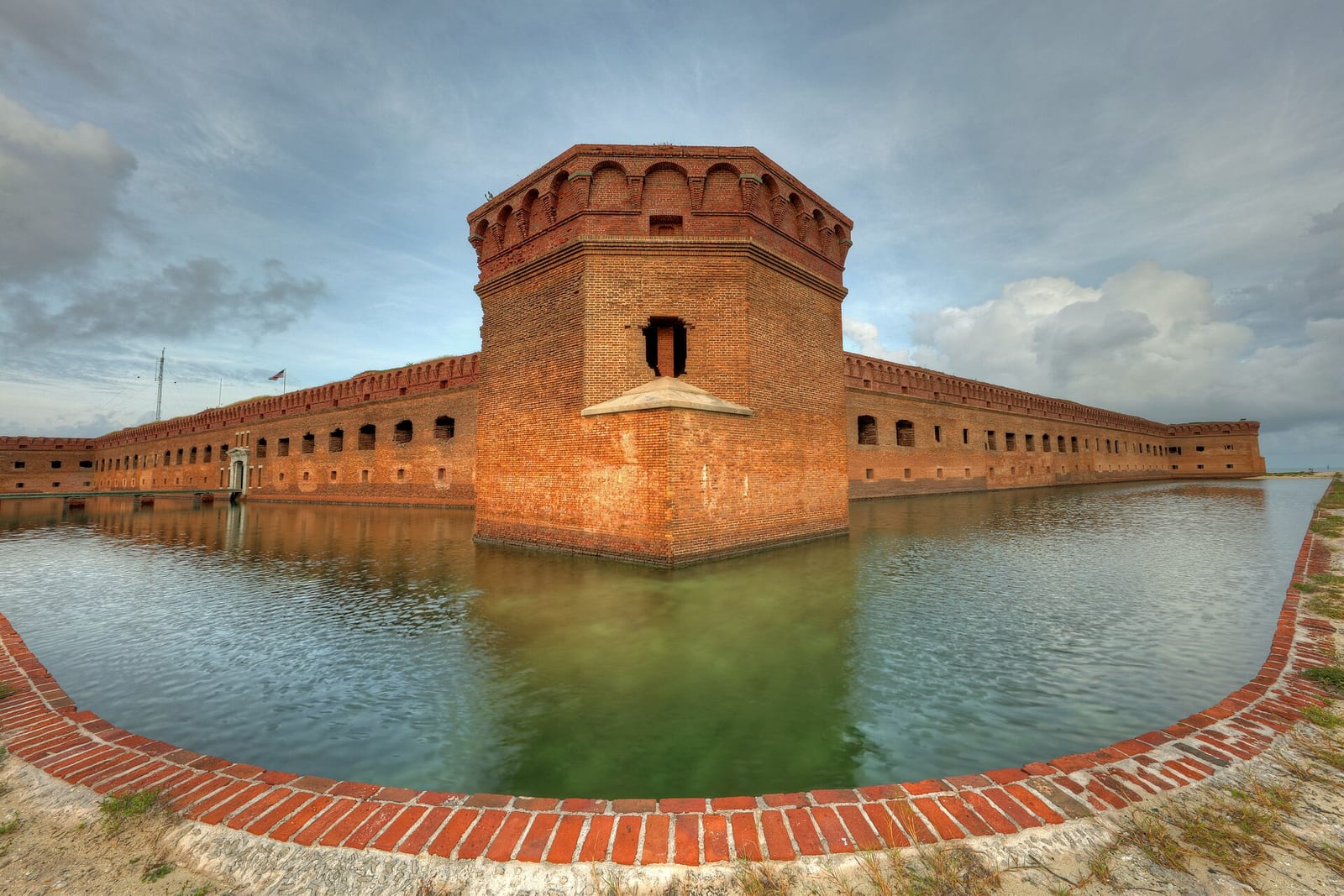 North Swim Beach: red brick fort surrounded by water with moat