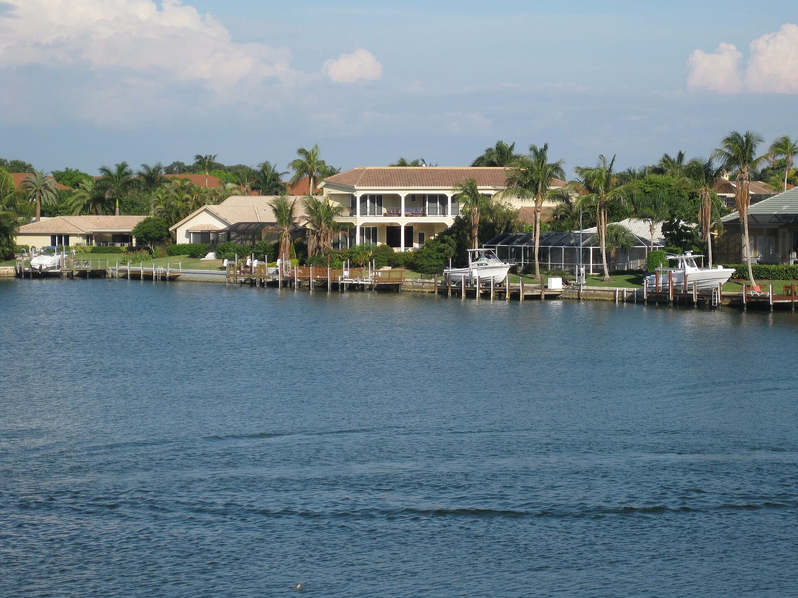 Park Shore Beach: waterfront residential homes with docks and palm trees along canal