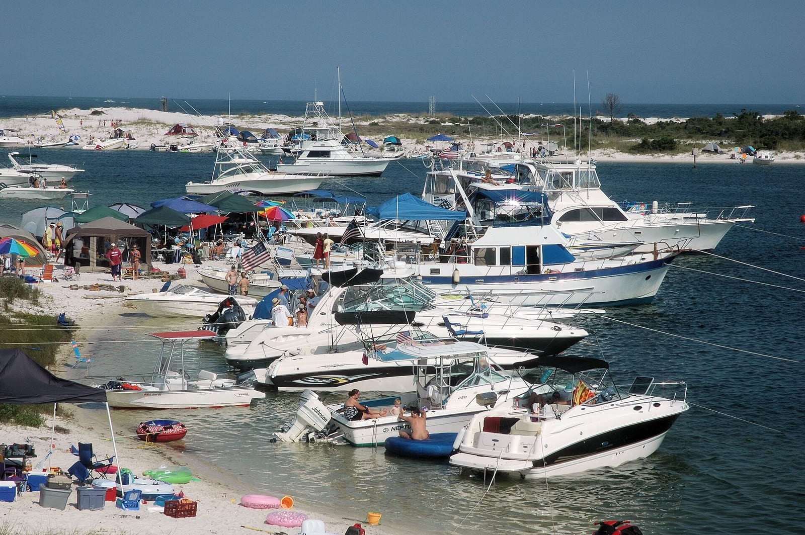 Robertson Island: moored fishing boats and yachts at sandy beach harbor inlet