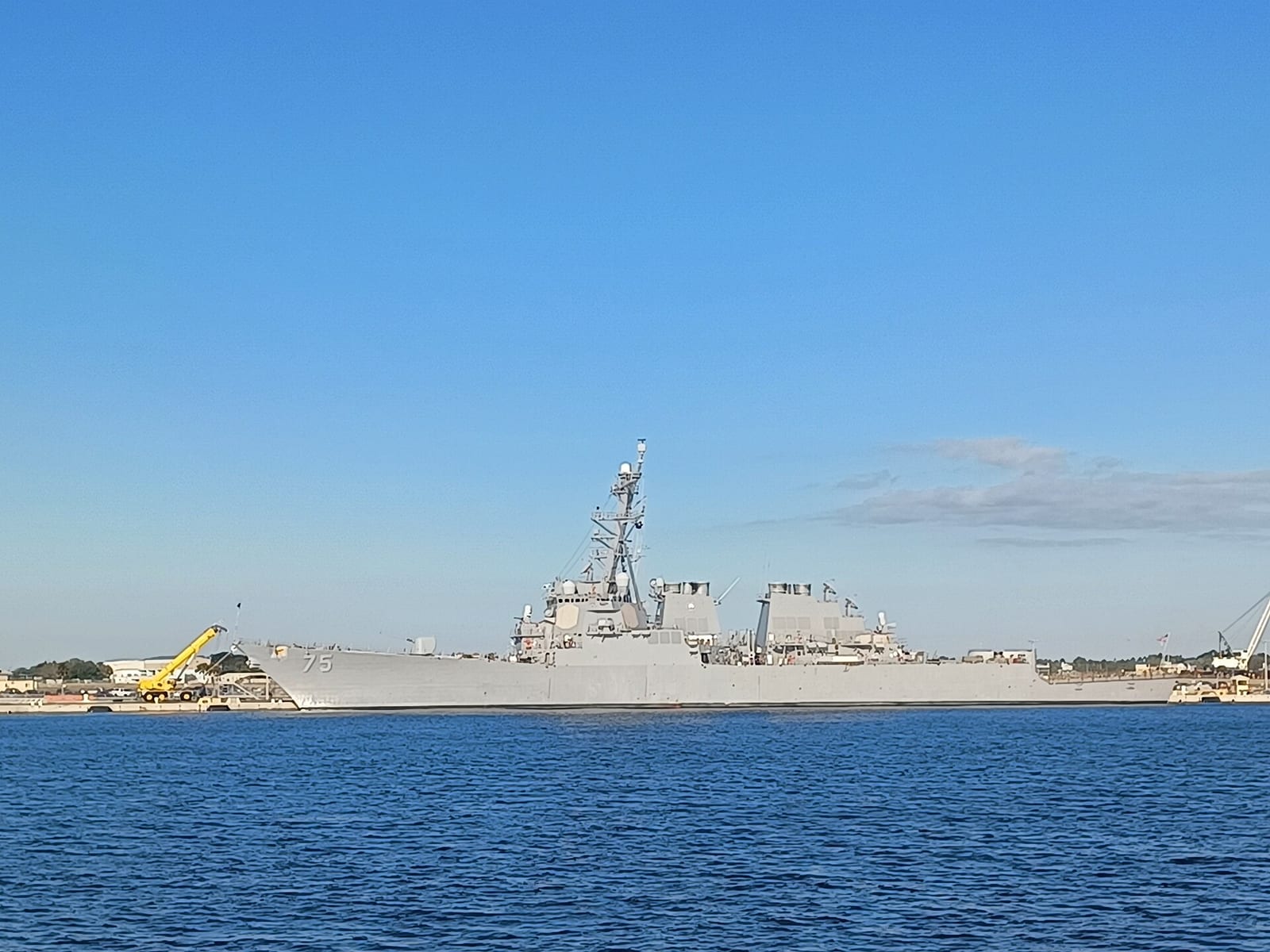 Seminole Beach: military naval vessel docked at harbor with beach in background