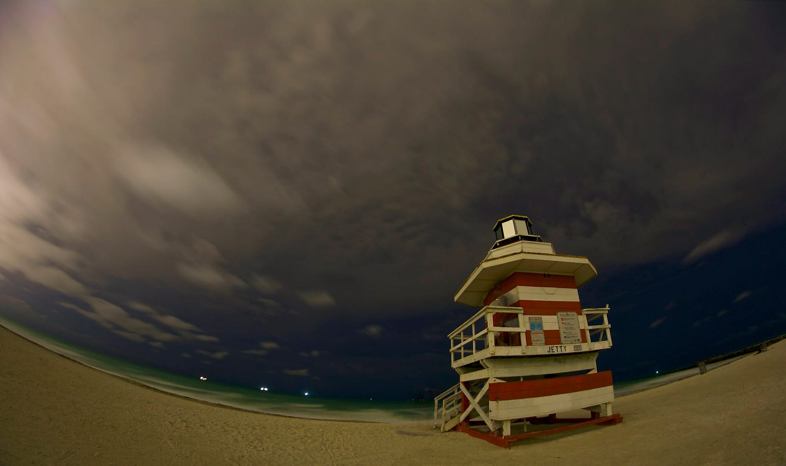 South Pointe Beach: lifeguard tower on sandy beach under stormy sky