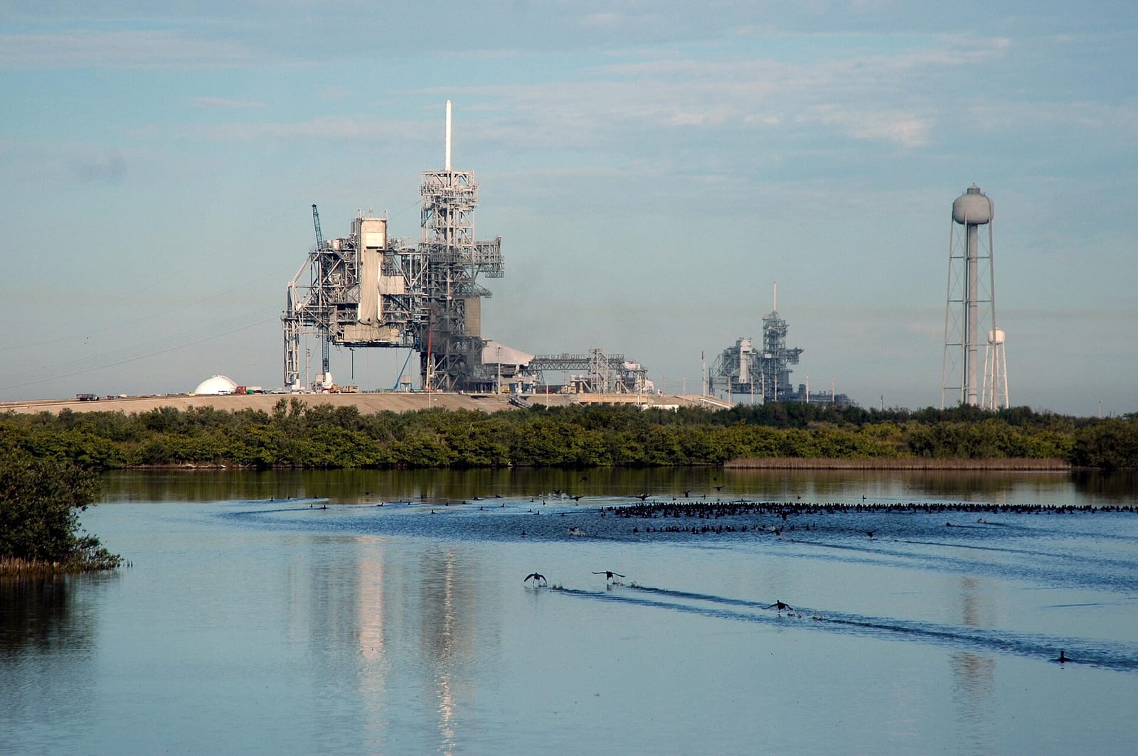 Titusville Beach: nASA launch facility with water, mangroves, and industrial structures