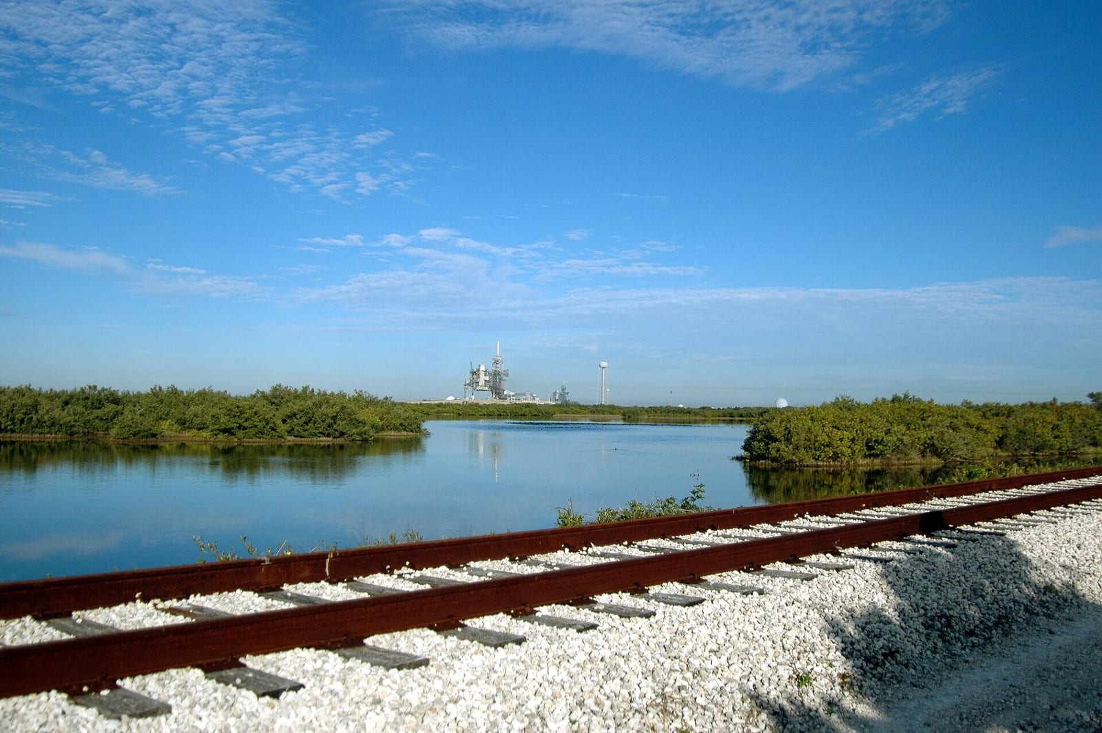 Titusville Beach: industrial facility viewed across mangrove wetlands and waterway