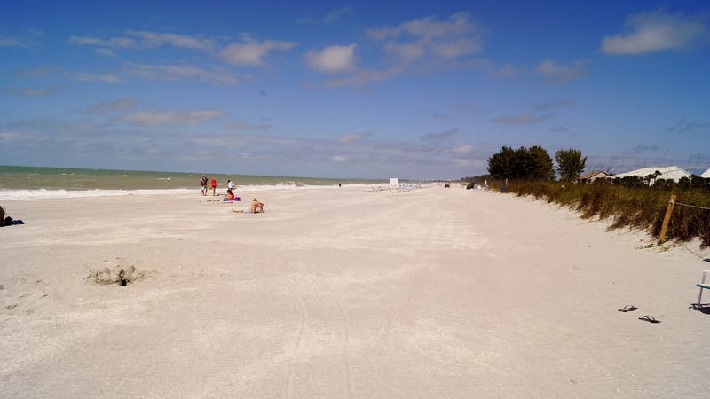 Turner's Beach: wide sandy beach with scattered beachgoers, dunes, and calm water