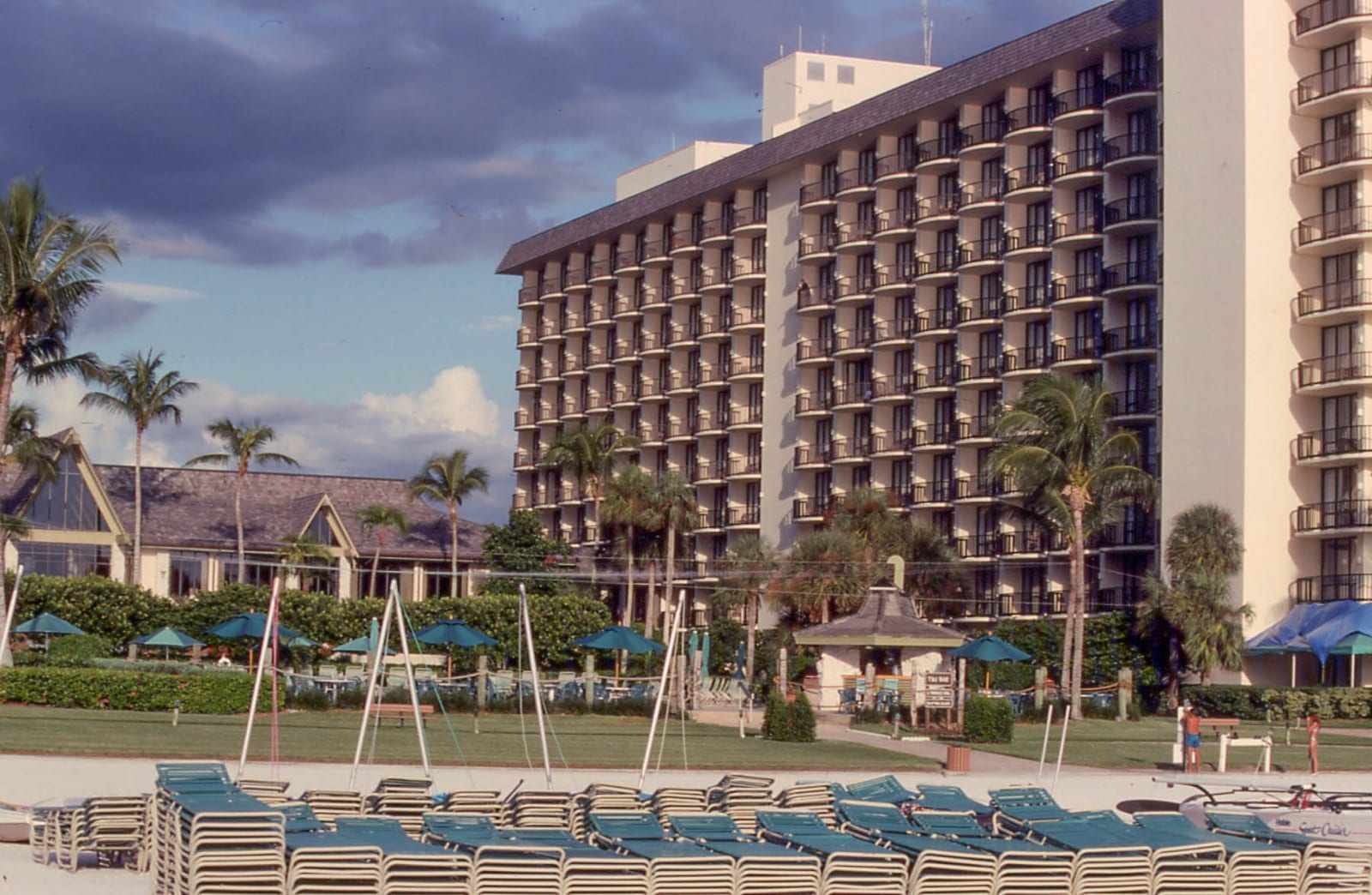 Winterberry Beach: beach resort with loungers, buildings, palm trees, and manicured grounds